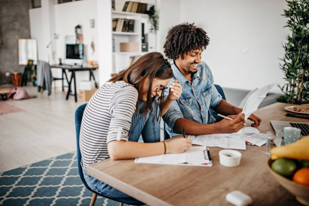istock Young couple calculating monthly expenses at home 1216679485