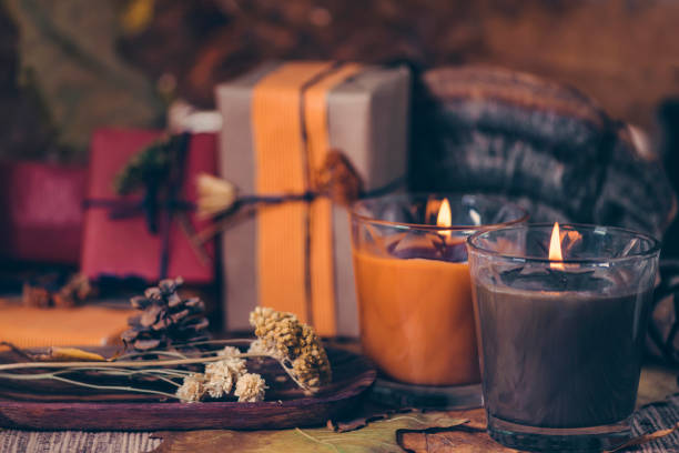 istock Scented Candles, Presents, Dried Flowers and Leaf Decoration on a Table 1216680434