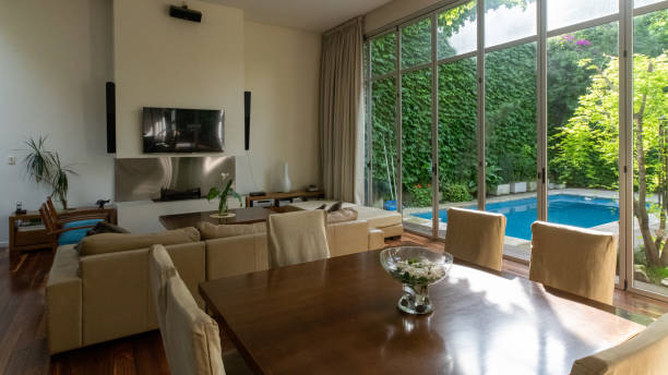 istock Living and dining room in a house with a pool 1216681480