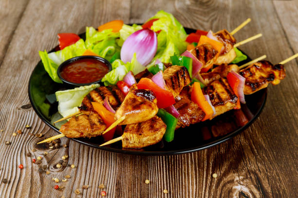 istock Pork shish kebab on skewer on wooden background. 1216684931