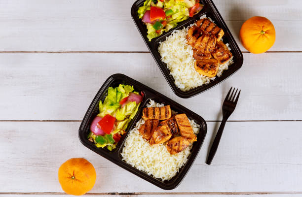 istock Ready meal to eat on food container with drink and orange. 1216685057