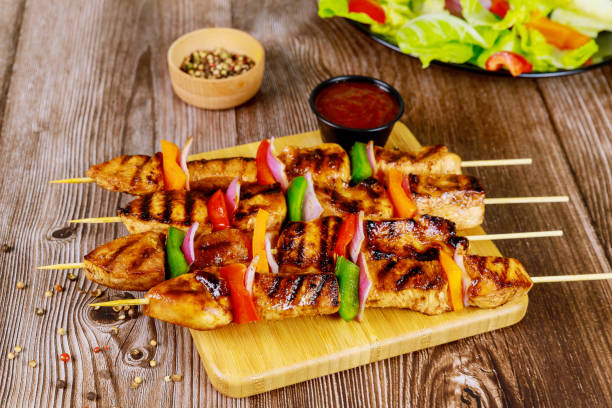 istock Grilled chicken on wooden skewer with sauce. 1216685164