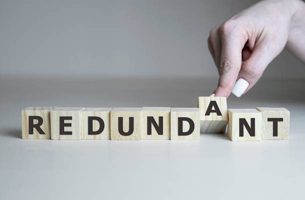 istock redundancy - cube with letters and words from the computer, software, internet categorie, wooden cubes 1216685246