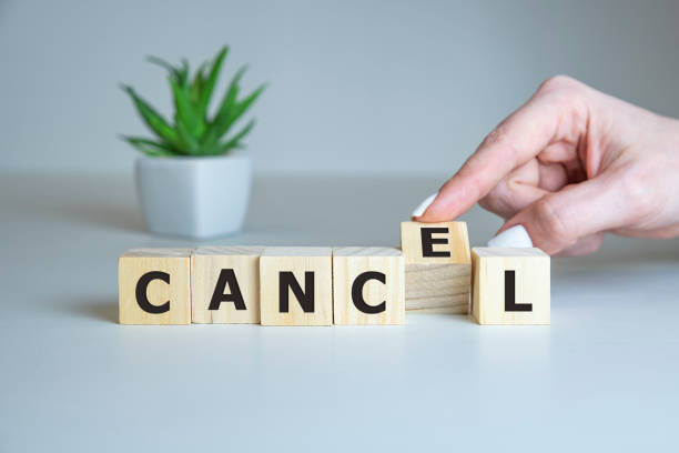 istock Cancel - words from wooden blocks with letters, postponed concept, top view background 1216685256