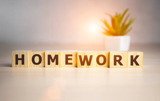 istock Wooden cubes with word Homework on office table.. 1216685384