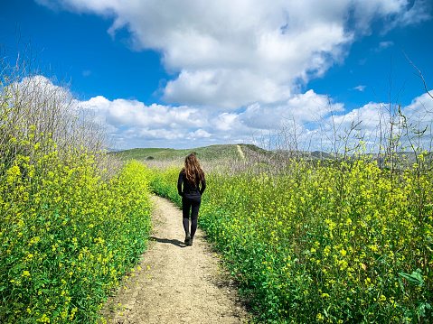 A lone woman gets out into nature for a walk to escape the crowds of Southern California. Shot in Spring, along the hills of San Juan Capistrano in Orange County.