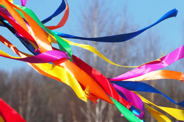 Traditional Czech Easter whip with colored ribbons from willow branches on the black background