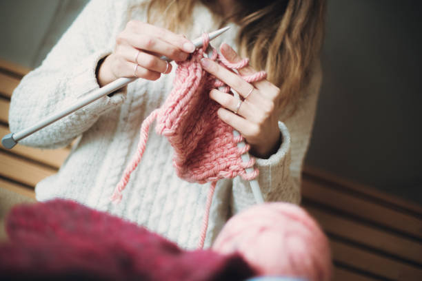 istock Close up on woman's hands knitting 1216687225