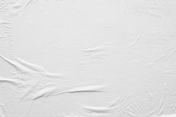 istock Blank white crumpled and creased paper poster texture background 1216687371