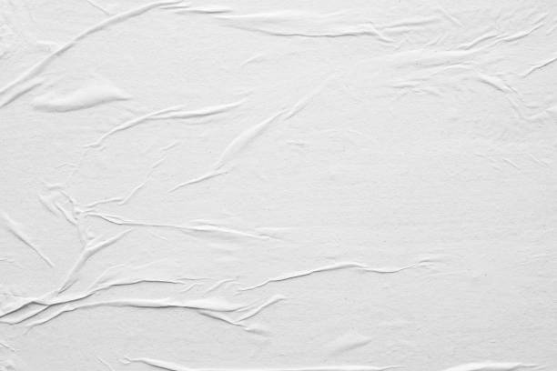 istock Blank white crumpled and creased paper poster texture background 1216687373