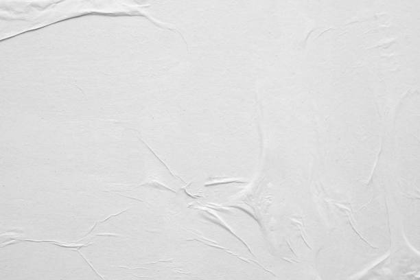 istock Blank white crumpled and creased paper poster texture background 1216687441