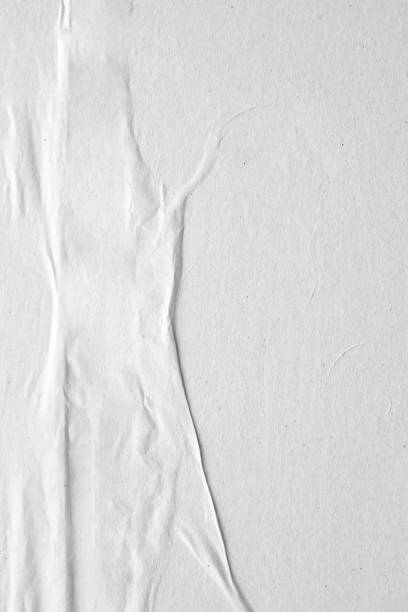 istock Blank white crumpled and creased paper poster texture background 1216687442