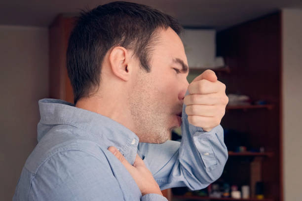 istock Young Man Coughing into his Elbow. Sick due Coronavirus concept. Prevention Measures Preventing COVID -19 Spread. sore throat. flu or SARS . 1216687570