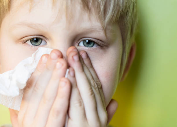 istock Portrait of a sick boy cleaning his nose 1216688421