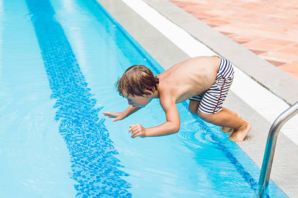 istock happy boy kid jumping in the pool 1216689483