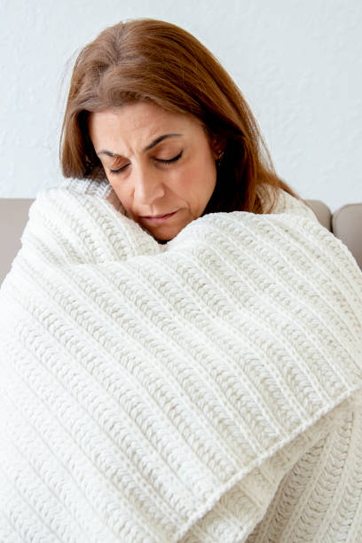 istock Sick woman on couch 1216690520