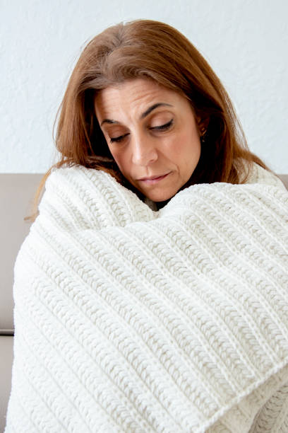 istock Sick woman on couch 1216690533