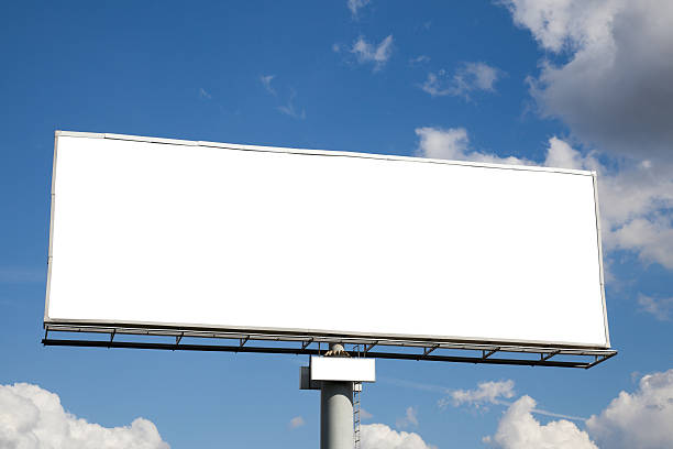 istock A blank white billboard against a blue cloudy sky 121669586