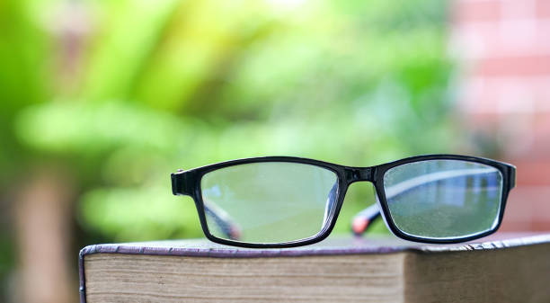 istock Spectacles on top of a book. Green nature background. 1216696643