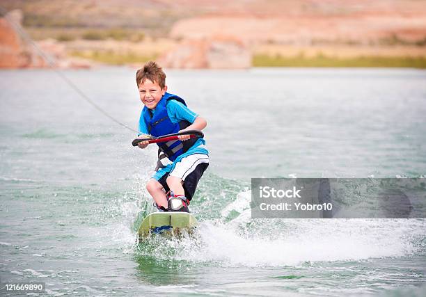Child Learning To Wakeboard Stock Photo - Download Image Now - Wakeboarding, Child, Lake