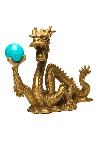 istock Chinese Dragon holding a turquoise sphere isolated on white 1216699107