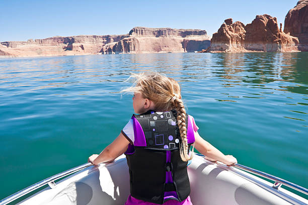 Little Girl on a boat ride at Lake Powell A young girl looking out on the front of a boat at beautiful Lake Powell National Recreation Area lake powell stock pictures, royalty-free photos & images