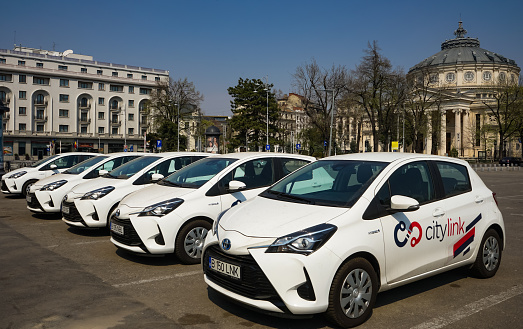 Bucharest, Romania - March 30, 2020: Several Toyota Yaris Hybrid cars belonging to the Romanian renting car service Citylink are parked waiting for customers near Athenee Palace Hilton Bucharest hotel