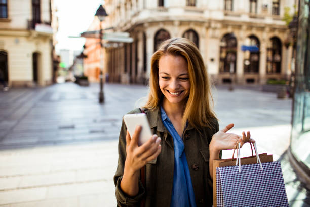 istock Young Lady shopping and using a Phone 1216705788