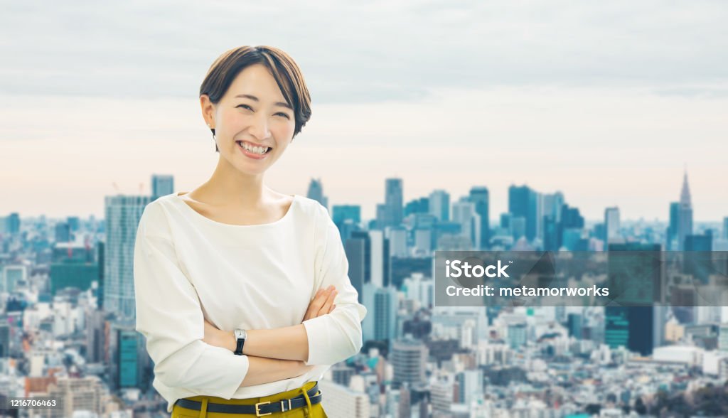Middle aged asian businesswoman in front of the city. Women Stock Photo