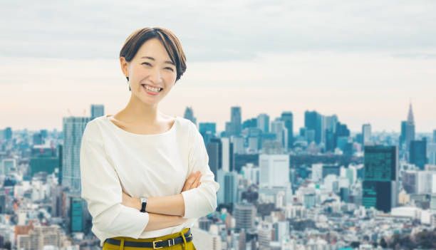 Middle aged asian businesswoman in front of the city. Middle aged asian businesswoman in front of the city. japanese woman stock pictures, royalty-free photos & images