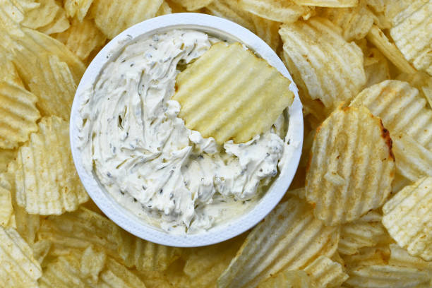 Ripple Potato Chips and Creamy Dip A top view image of ripple potato chips and creamy fresh chip dip. dipping sauce stock pictures, royalty-free photos & images