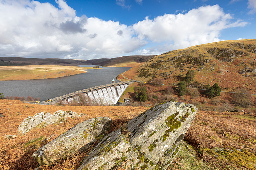 A view across the Elan Valley showing the dam overflow after the rain