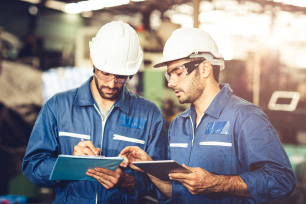 istock Engineer audit worker working team together with safety uniform and white helmet to work in industry factory handle tablet and checklist. 1216709795