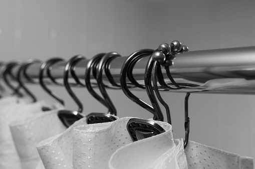 A shower curtain, curtain rod and hooks in black and white.