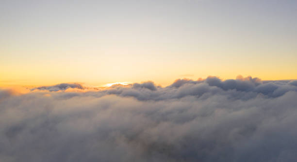 istock Aerial view White clouds in blue sky. View from drone. Aerial top view cloudscape. Texture of clouds. View from above. Sunrise or sunset over clouds. Panorama clouds 1216714262
