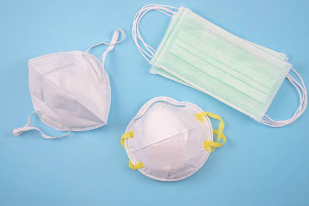 istock Three protective masks on a blue background, Many masks. Top view. 1216714883