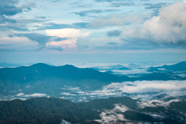 istock Cloud layers on mountain horizon with green grass 1216715838