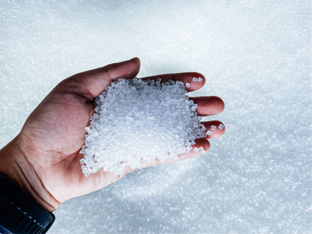 istock hand hold and touching plastic pellets. plastic polymer granules color clear blue 1216717979