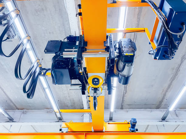 overhead crane and machine inside factory building, industrial background. - pulley hook crane construction imagens e fotografias de stock