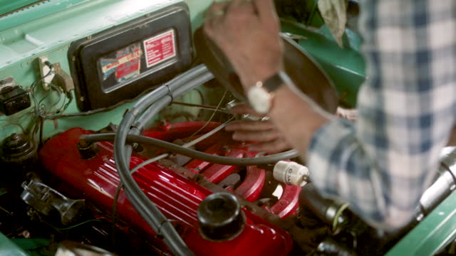 A man changes the filter on an engine