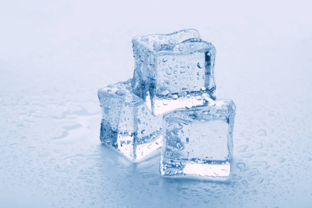 istock several melted ice cubes with drops on a light background with blue tinting 1216720040