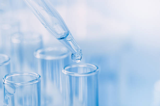 istock Laboratory glassware with a dropper dripping liquid into a test tube. scientific laboratory test tubes, laboratory equipment 1216720177
