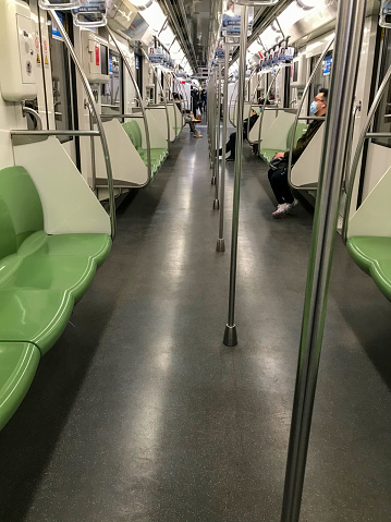 Shanghai, China - Apr 03, 2020: Empty metro carriage, people waring masks in the subway. Because of the coronavirus epidemic, less people choose to go to work by underground