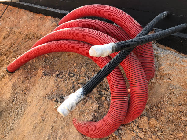 istock coiled corrugated pipes and high voltage cables 1216721329