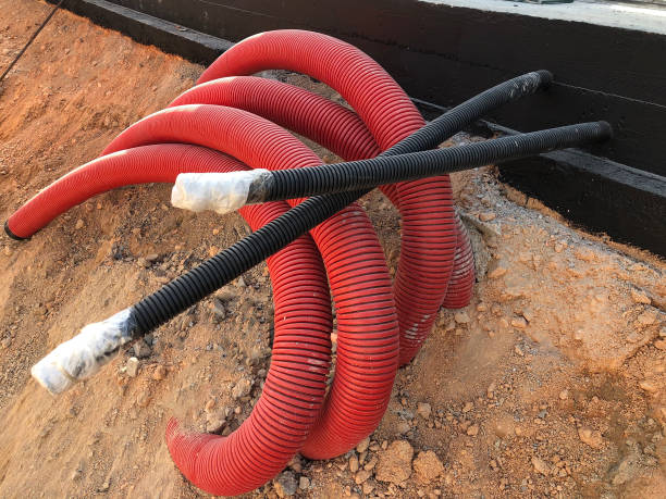 istock coiled corrugated pipes and high voltage cables 1216721356