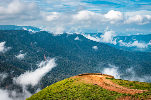 mountain with green grass and beautiful sky image is showing the amazing beauty and art of nature. This image is taken at karnataka india from hilltop.
