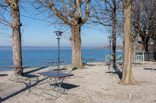 An empty beer garden at a sunny spring day. In Bavaria all restaurants are closed for visitors due to restrictions related to the Coronavirus (Covid-19).
