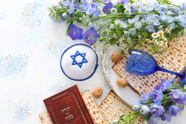 istock Pesah celebration concept (jewish Passover holiday). Traditional book with text in hebrew: Passover Haggadah (Passover Tale) 1216723172