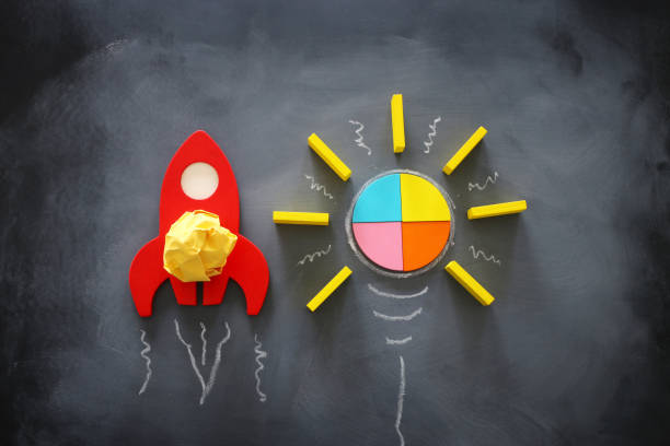 istock education or innovation concept. Wooden rocket over blackboard background. top view 1216723217