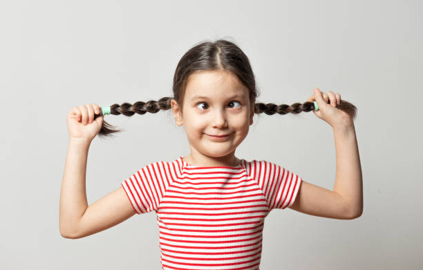 Squint Girl Six years old squint girl in gray background. squint eyes stock pictures, royalty-free photos & images
